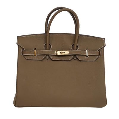 Brown handbag with gold hardware on a white background