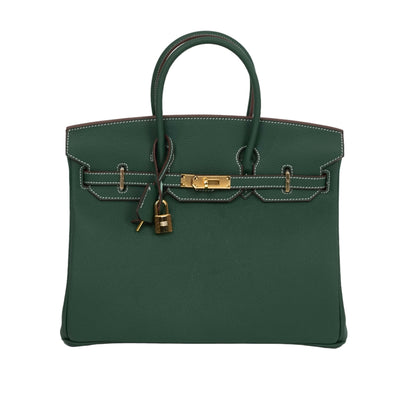 Green handbag with gold hardware on a white background