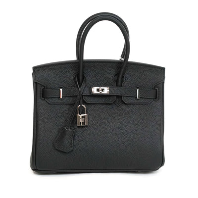 Black handbag with silver hardware on a white background