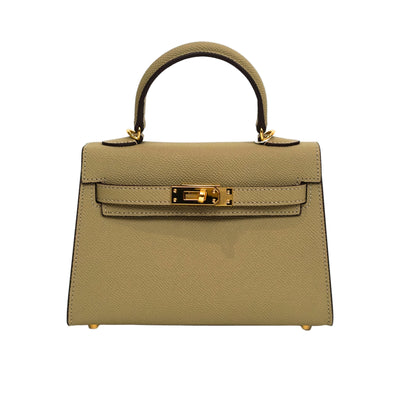 Beige handbag with gold hardware on a white background