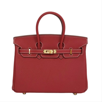 Red handbag with gold hardware on a white background