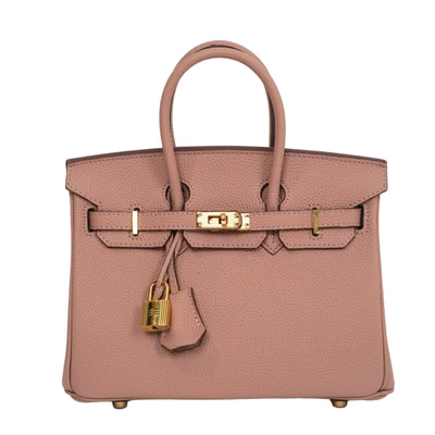 Pink handbag with gold hardware on a light gray background