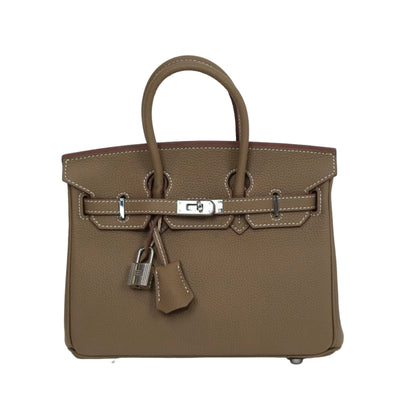 Brown handbag with silver hardware on a white background